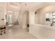 Spacious entryway with high ceilings, tiled flooring, and access to a laundry room and staircase at 1339 Echo Creek St, Henderson, NV 89052