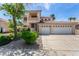 Charming two-story home featuring a three-car garage, landscaped yard, and a sunny sky at 1339 Echo Creek St, Henderson, NV 89052