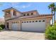Two-story home featuring a three-car garage, light-colored exterior, and red tile roof at 1339 Echo Creek St, Henderson, NV 89052