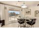 Bright kitchen with white cabinets, dark counter tops, and a sunny breakfast nook near a sliding glass door at 1339 Echo Creek St, Henderson, NV 89052