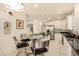 Open concept kitchen with breakfast nook, white cabinets, dark countertops, stainless appliances, and tile flooring at 1339 Echo Creek St, Henderson, NV 89052