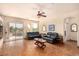 Bright living room features neutral walls, wood floors, leather furniture and access to the pool area at 1339 Echo Creek St, Henderson, NV 89052