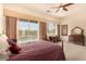 Spacious bedroom with a ceiling fan, large windows, and access to the pool area at 1339 Echo Creek St, Henderson, NV 89052