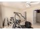 Workout room with an elliptical machine, weights, and natural light from the large window at 1339 Echo Creek St, Henderson, NV 89052