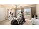 Workout room with an elliptical machine, weights, and natural light from the large window at 1339 Echo Creek St, Henderson, NV 89052