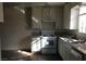 Galley kitchen features white cabinets, laminate countertops, and stainless steel appliances at 146 Greenbriar Townhouse Way, Las Vegas, NV 89121
