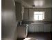 Galley kitchen features white cabinets, laminate countertops, and stainless steel appliances at 146 Greenbriar Townhouse Way, Las Vegas, NV 89121