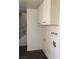 Functional laundry area featuring white cabinets for storage and essential utility connections at 146 Greenbriar Townhouse Way, Las Vegas, NV 89121