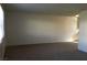The living room is spacious and bright with carpeted floors at 146 Greenbriar Townhouse Way, Las Vegas, NV 89121