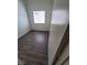 This bedroom features gray wood flooring, a window to provide light, and painted walls at 2100 Fred Brown Dr, Las Vegas, NV 89106