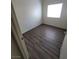 This bedroom features gray wood flooring, a window to provide light, and painted walls at 2100 Fred Brown Dr, Las Vegas, NV 89106