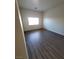 This bedroom features gray wood flooring, a window to provide light, and painted walls at 2100 Fred Brown Dr, Las Vegas, NV 89106