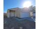 Front exterior of a single story beige colored home, concrete driveway, small front yard at 2100 Fred Brown Dr, Las Vegas, NV 89106