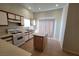 Bright kitchen featuring an island, tan tile flooring, plenty of cabinets, and a sliding glass door at 2100 Fred Brown Dr, Las Vegas, NV 89106