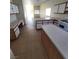 Open concept kitchen with white appliances, tile floor, work space and view into living room at 2100 Fred Brown Dr, Las Vegas, NV 89106