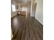 Spacious living room with wood-look flooring flowing into the kitchen area with island and stainless steel appliances at 2100 Fred Brown Dr, Las Vegas, NV 89106