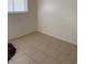 An empty bedroom featuring tiled floors, a single window and white paint at 2109 Glider St, North Las Vegas, NV 89030