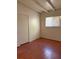 Cozy bedroom with white walls, wood floors, and a window with blinds at 2109 Glider St, North Las Vegas, NV 89030
