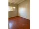 A simple bedroom with wood-look laminate floors and a window with blinds at 2109 Glider St, North Las Vegas, NV 89030