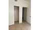 An empty bedroom featuring tiled floors, a closet and white paint at 2109 Glider St, North Las Vegas, NV 89030