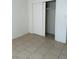 View of a bedroom featuring neutral tile flooring and a built-in closet at 2109 Glider St, North Las Vegas, NV 89030