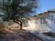 A single story home with white paint, a desert landscape, security doors and clearly marked addresses at 2109 Glider St, North Las Vegas, NV 89030