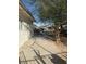 An exterior view of the side of a home and the sidewalk at 2109 Glider St, North Las Vegas, NV 89030
