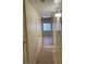 Hallway with tile flooring, closet, and a glimpse into a room with a window at 2109 Glider St, North Las Vegas, NV 89030