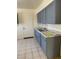 Features stainless sink, gray cabinets, and tile flooring at 2109 Glider St, North Las Vegas, NV 89030