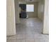 An empty living room featuring tiled floors, a door and a single window at 2109 Glider St, North Las Vegas, NV 89030