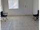 An empty living room featuring tiled floors, a door and a single window at 2109 Glider St, North Las Vegas, NV 89030