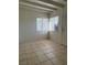 Bright living room with tiled flooring, large windows, and natural light at 2109 Glider St, North Las Vegas, NV 89030