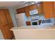 Bright kitchen featuring white appliances, wooden cabinets, and a breakfast bar at 2200 Highpointe Dr # 201, Laughlin, NV 89029