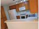 Bright kitchen featuring white appliances, wooden cabinets, and a breakfast bar at 2200 Highpointe Dr # 201, Laughlin, NV 89029