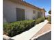 Neutral-toned home exterior with a tiled roof, wide driveway, and manicured landscaping at 227 Big Horn Dr, Boulder City, NV 89005