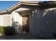 Home exterior featuring a solid brown front door with a covered entryway and address number at 227 Big Horn Dr, Boulder City, NV 89005