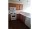 Traditional kitchen features wood cabinets, white appliances and countertops at 227 Big Horn Dr, Boulder City, NV 89005