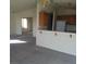 Open-concept living and kitchen space with a breakfast bar and carpet at 227 Big Horn Dr, Boulder City, NV 89005