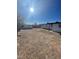 A backyard that features a chainlink fence, dirt, partial grass, and trees at 2564 San Marcos St, Las Vegas, NV 89115