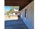 A covered back patio overlooking a fenced backyard that has dirt and some plants at 2564 San Marcos St, Las Vegas, NV 89115
