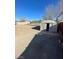 Backyard featuring dirt, partial grass, trees, and a shed with open doors at 2564 San Marcos St, Las Vegas, NV 89115