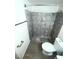 Recently updated bathroom featuring a gray tiled walk in shower, hardwood floors, and white wall paint at 2564 San Marcos St, Las Vegas, NV 89115