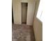 A close up of a carpeted bedroom featuring a white closet with sliding doors and a shelf and hanging rod at 2564 San Marcos St, Las Vegas, NV 89115