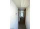 Hallway view showcasing wood floors, white walls, a storage closet and natural light at 2564 San Marcos St, Las Vegas, NV 89115