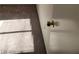 This is a neutral toned hallway with light shining on the carpet and a white door with a gold knob at 2564 San Marcos St, Las Vegas, NV 89115