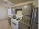 Well lit kitchen featuring granite countertops and stainless steel refrigerator at 2564 San Marcos St, Las Vegas, NV 89115
