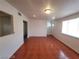 View of a bright living room showing shiny red-brown floor and white wall at 2564 San Marcos St, Las Vegas, NV 89115