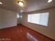 Living room featuring glossy floors, bright lighting, and a large window at 2564 San Marcos St, Las Vegas, NV 89115