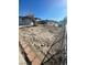 Desert-landscaped yard with minimal greenery and fencing, showing the property boundaries at 2564 San Marcos St, Las Vegas, NV 89115