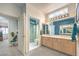 Bathroom with double vanity, framed mirrors, open shower and adjacent doorway to bedroom at 2608 Golfside Dr, Las Vegas, NV 89134